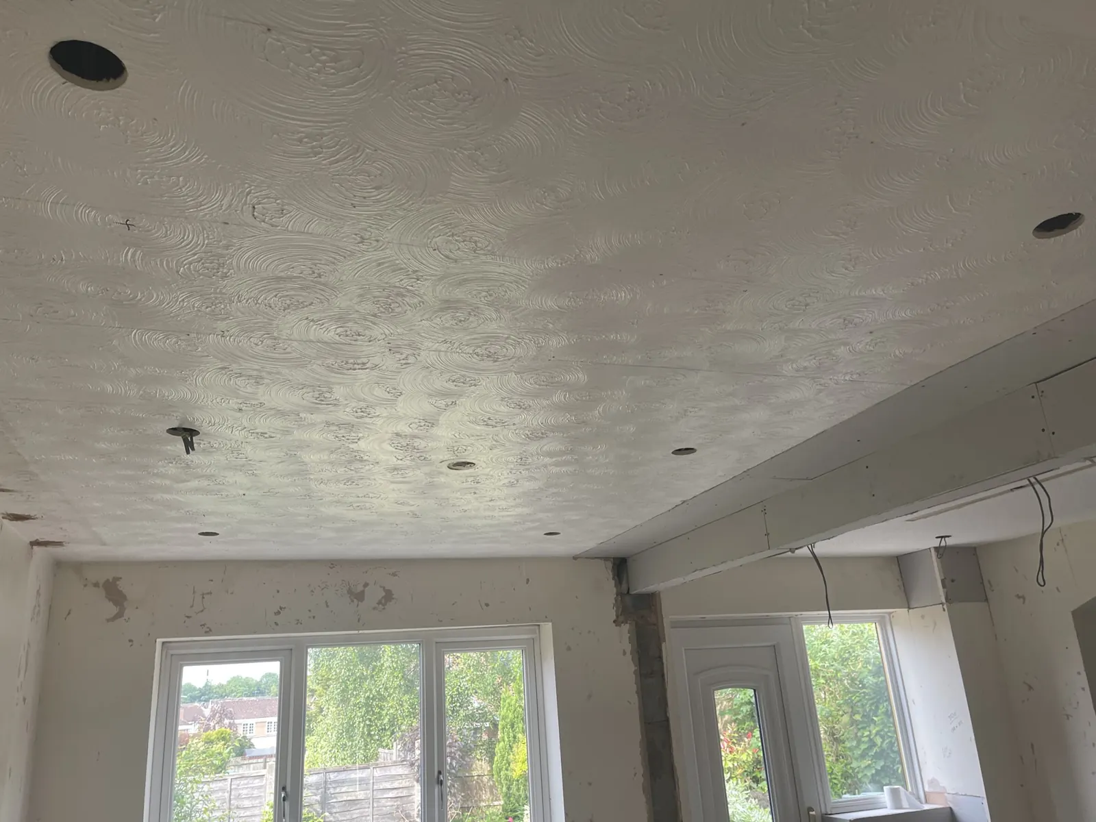 A textured ceiling in a living room, photographed before I plastered over it.