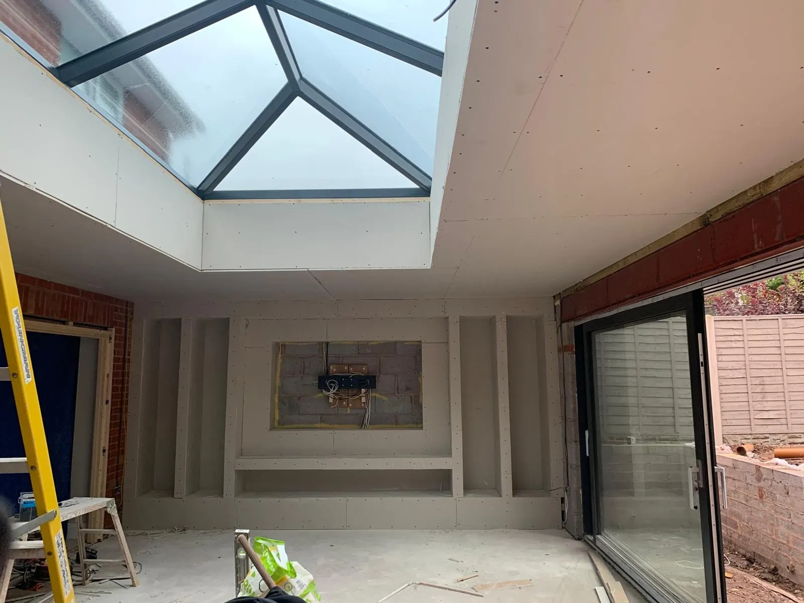 Insulated plasterboard going onto the original wall next to an extension.