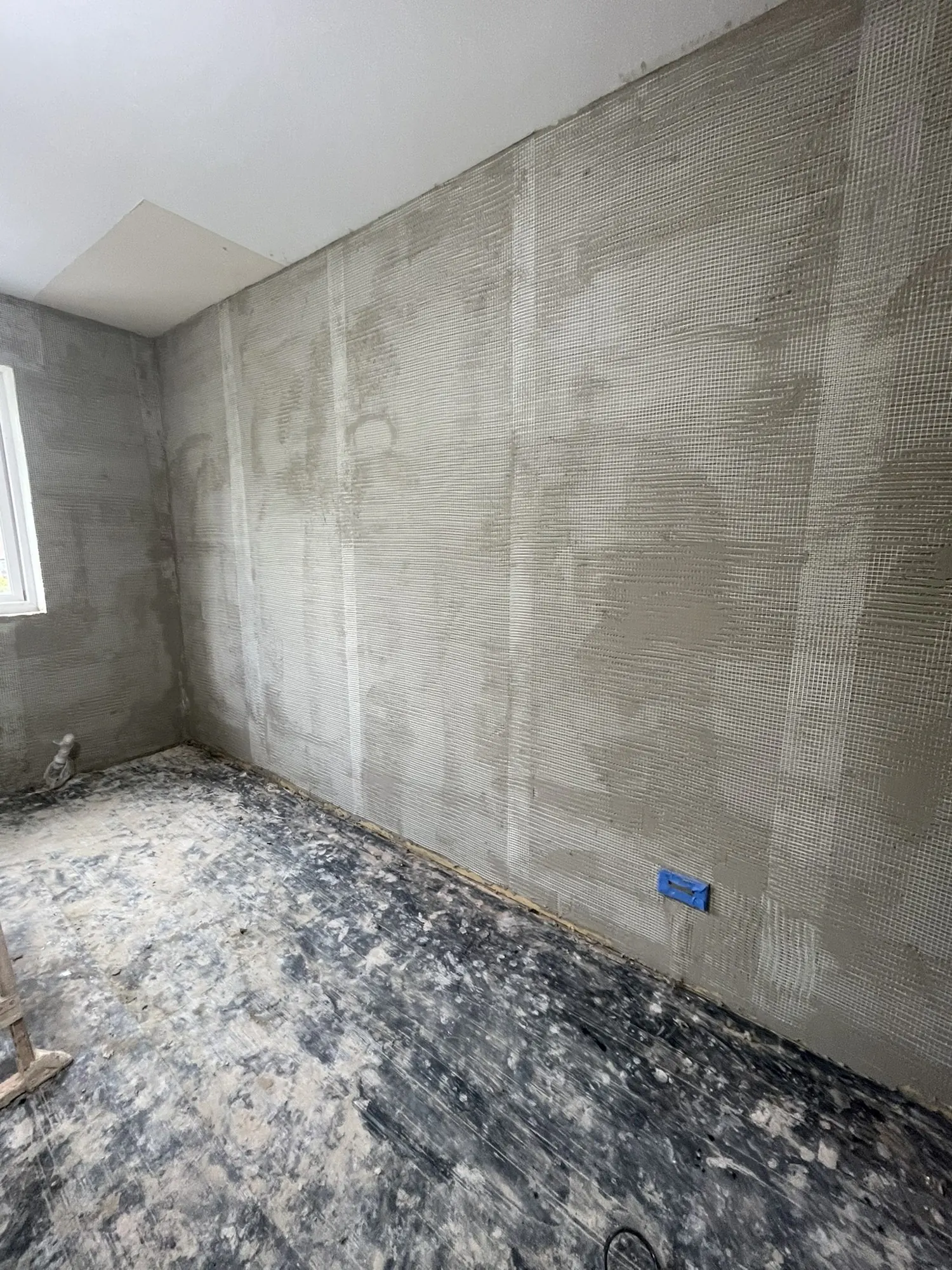 Lime plaster with a reinforcing mesh on a solid wall, from one of my jobs.