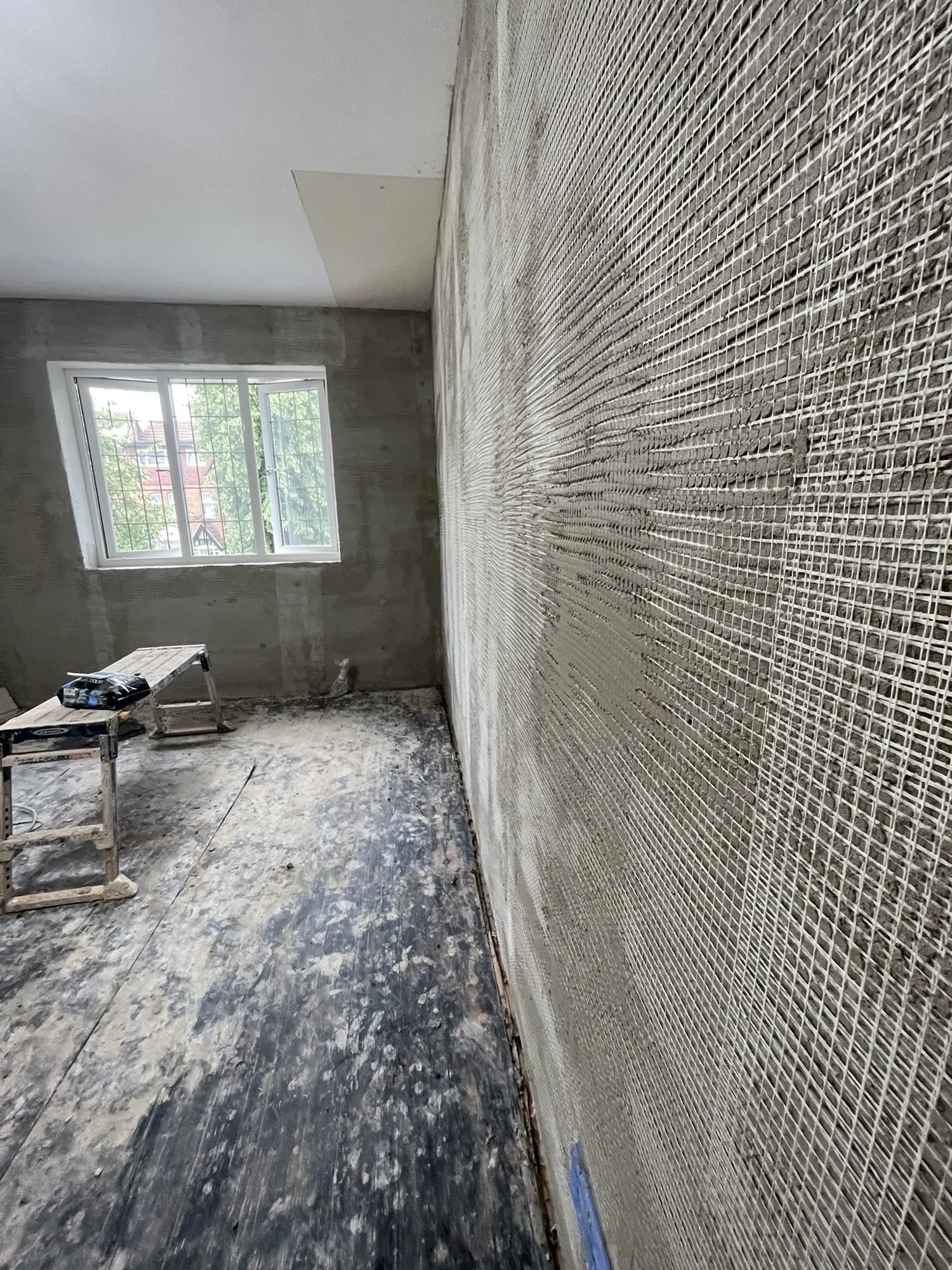 Lime plaster going on over mesh, the finish I use on breathable systems.