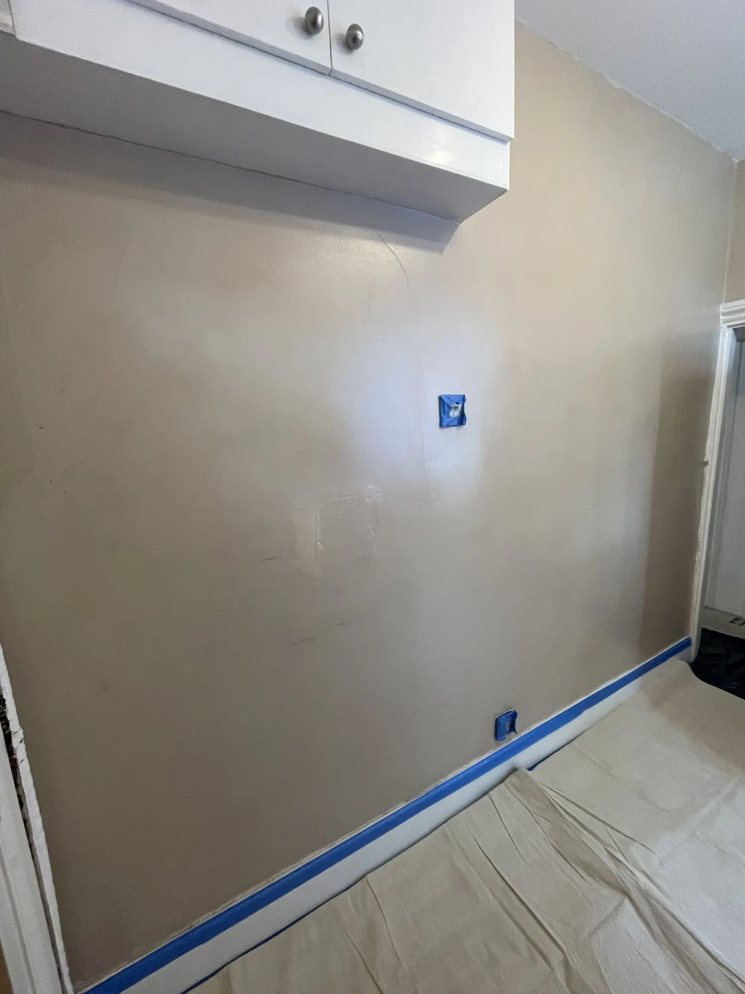 A freshly plastered wall on one of my jobs, with the floor and skirting protected.