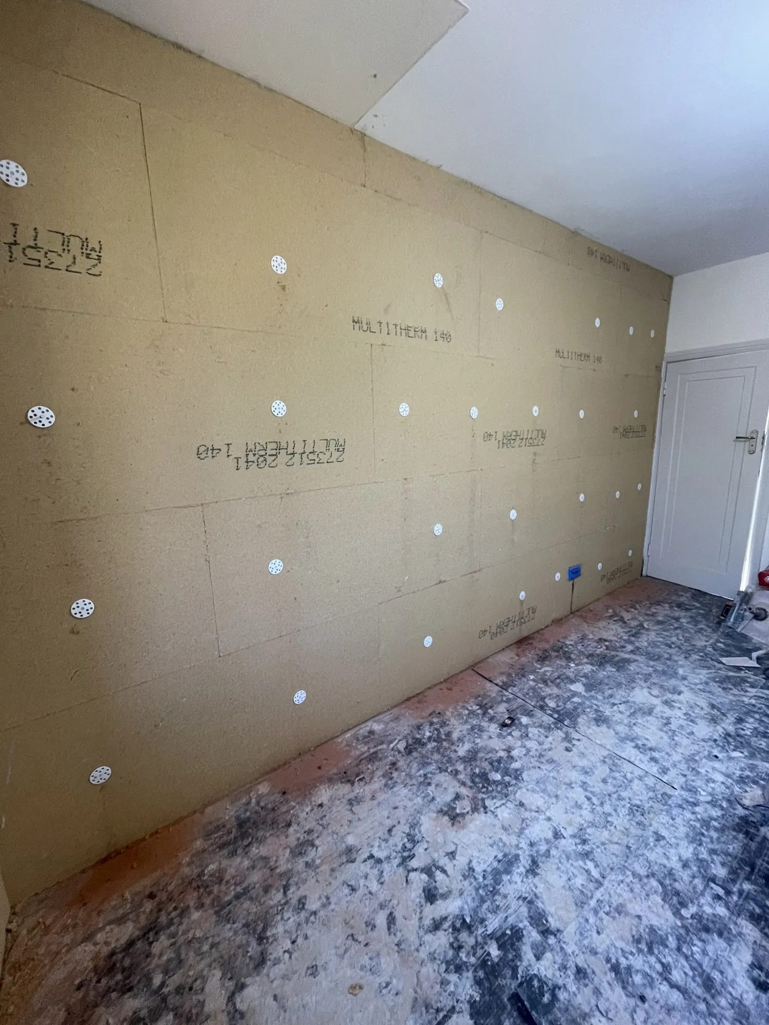 Real photo from this bedroom: 40mm wood fibre boards fixed to the main solid brick wall.